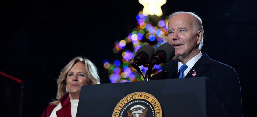 President Joe Biden speaks as First Lady Jill Biden looks on during the National Christmas tree lighting ceremony on the Ellipse of the White House on Nov. 30, 2023. Biden gave federal employees Dec. 24 off Thursday.