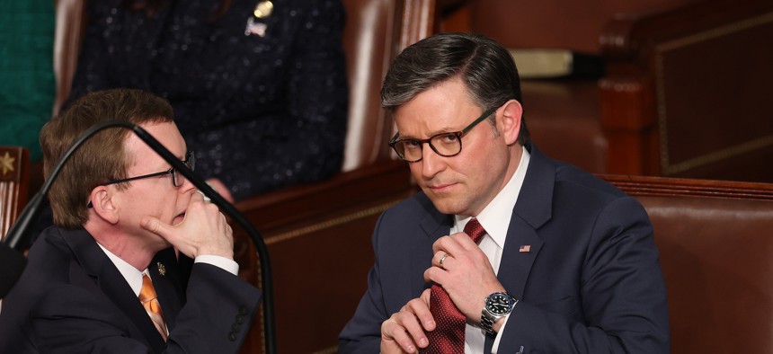 Rep. Mike Johnson, R-La., talks to Rep. Dusty Johnson, R-S.D., as the House votes for a speaker in the U.S. Capitol Building on Jan. 3, 2025. 