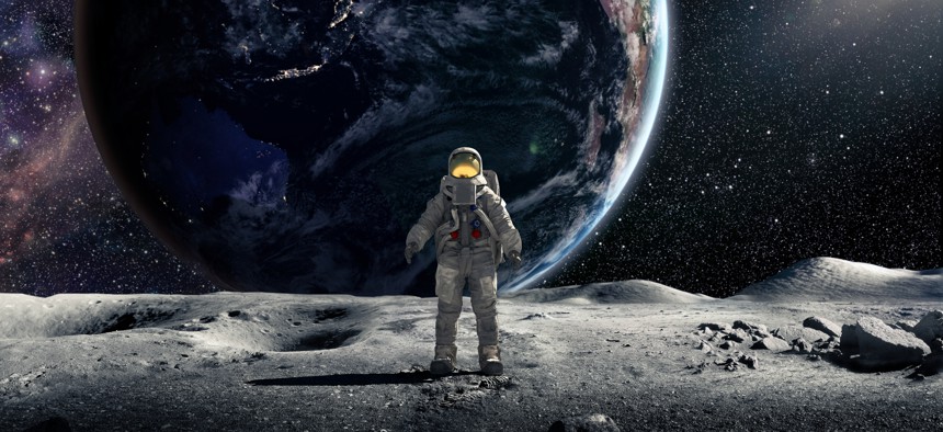 An astronaut wearing full spacesuit and backpack, standing in the lunar surface of the moon facing the camera. Behind the astronaut is the earth, with night lights visible from some countries and the sun rim lighting on side. Earth Image from NASA: