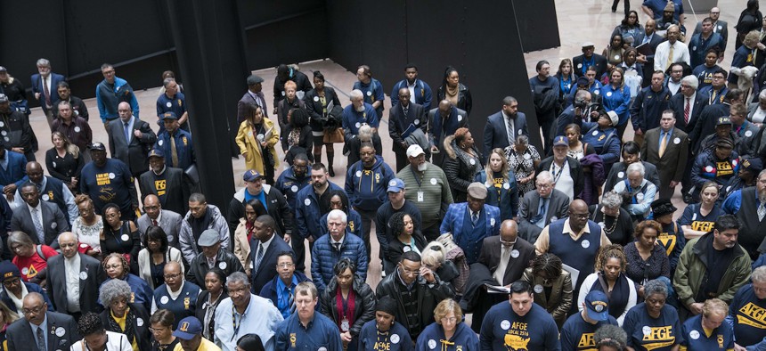 Members and supporters of the American Federation of Government Employees in the Hart Senate Office Building Atrium in Feb. 11, 2020. The EEOC has recommended that agencies undertake efforts to identify and address barriers that create gender pay differences among federal workers. 