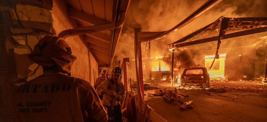 Firefighters battle the Eaton Fire on Jan. 8, 2025, in Altadena, Calif. Hundreds of U.S. Forest Service personnel are on the frontlines of the fires, and the Federal Emergency Management Agency is helping to coordinate the federal response.