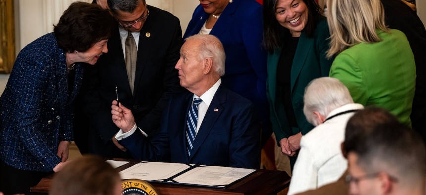 President Biden is greeted by Sen. Susan Collins, R-Maine, as he prepares to sign the Social Security Fairness Act on Jan. 5, 2025.