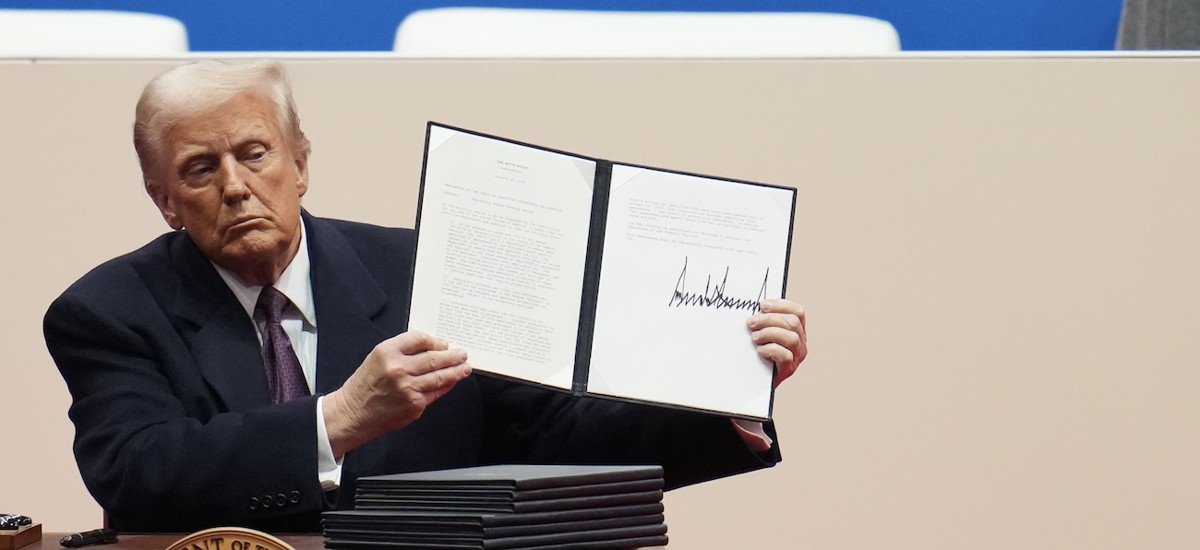 President Donald Trump holds up an executive order after signing it during an indoor inauguration parade at Capital One Arena on Jan. 20, 2025 in Washington, D.C. 