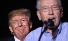 President Donald Trump smiles as Sen Chuck Grassley, R-Iowa, speaks during a rally at the Iowa State Fairgrounds on Oct. 9, 2021, in Des Moines, Iowa. Grassley previously said he "intends to defend" inspectors general. 