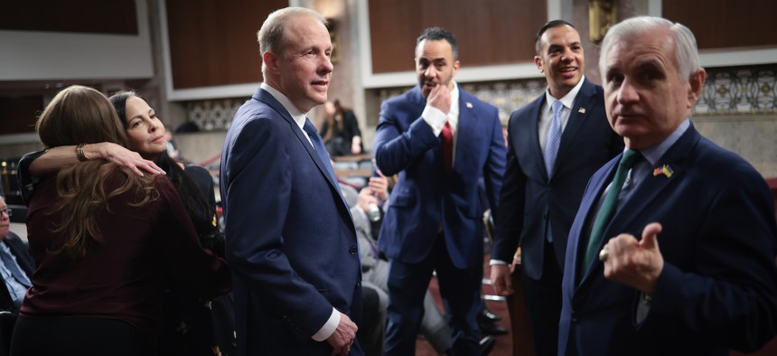 Stephen Feinberg (3rd L), U.S. President Donald Trump's nominee to be deputy secretary of defense, confers with Sen. Jack Reed (R) (D-RI) prior to testifying before the Senate Armed Services Committee confirmation hearing, February 25, 2025.