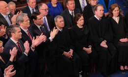 Members of President Donald Trump's cabinet, left, stand and applaud as members of the U.S. Supreme Court, including Chief Justice John Roberts, Associate Justices Elena Kagan, Brett Kavanaugh and Amy Coney Barrett, stay seated during the president's address to a joint session of Congress at the U.S. Capitol on March 4, 2025.