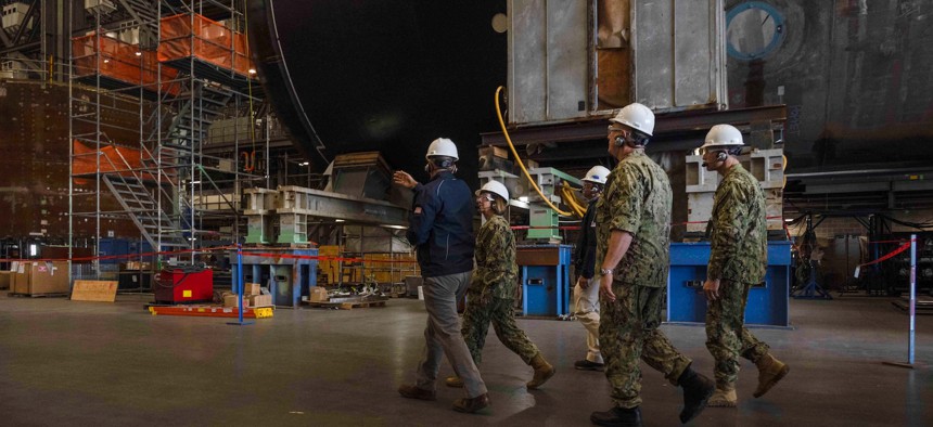 Navy leaders meet with officials from General Dynamics Electric Boat while touring the facility in Quonset Point, R.I., Oct. 19, 2023.