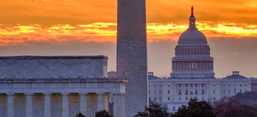 Daybreak turns the sky orange behind the Lincoln Memorial, Washington Monument and U.S. Capitol Building on March 18, 2025 in Washington, D.C.