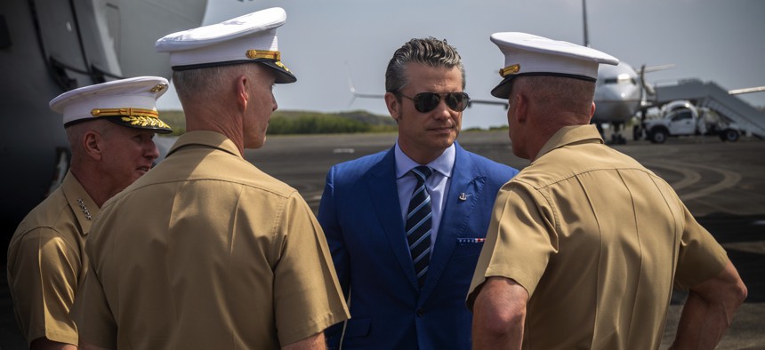 Defense Secretary Pete Hegseth speaks with three Marine Corps generals at Iwo To, Japan, on March 29, 2025.
