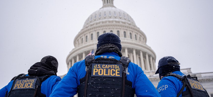 U.S. Capitol Police officers stand guard in a winter storm in the nation's capital on Jan. 6, 2025 in Washington, D.C. Two federal law enforcement employee associations are arguing for stronger exemptions to proposed benefits cuts.