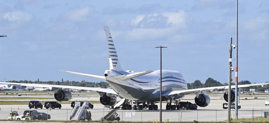The motorcade of President Donald Trump is parked next to an almost 13-year-old Qatari Boeing 747 sitting on the tarmac of Palm Beach International Airport on Feb. 15, 2025.