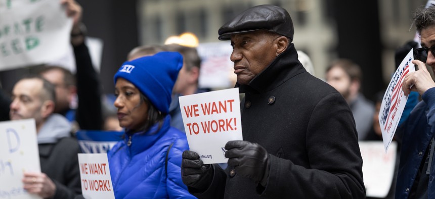 Federal employees rally in support of their jobs outside of the Kluczynski Federal Building on March 19, 2025 in Chicago.