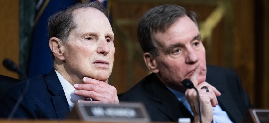 Ranking member Sen. Mark Warner, D-Va., right, and Sen. Ron Wyden, D-Ore., listen to testimony during a Senate Select Intelligence Committee confirmation hearing on Thursday, January 30, 2025. Warner and Wyden joined two other Democrats in calling for DHS to reinstate its Cyber Safety Review Board on May 30.