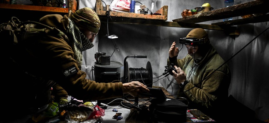 Fighters of the UAV unit of the Striletskyi Special Police Battalion of the Zaporizhzhia Regional Police Department control an FPV drone from a dugout during a combat mission in the Zaporizhzhia sector in Ukraine on May 23, 2025.