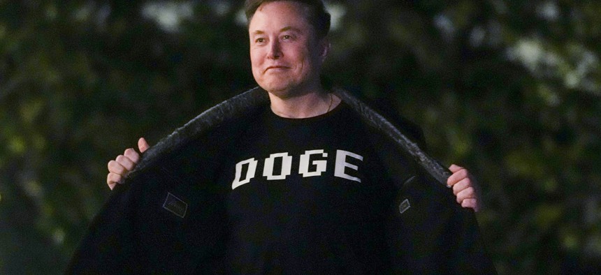 Elon Musk shows off a shirt that says "DOGE" as he walks on the South Lawn of the White House in Washington, D.C., on March 9, 2025. Civic tech leaders worry that DOGE's efforts have redefined how people view modernization work in government.