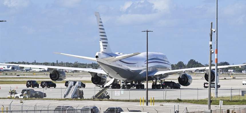 In this February 15, 2025, photo, President Donald Trump's motorcade is parked next to the Qatari Boeing 747 later accepted to be used as Air Force One.