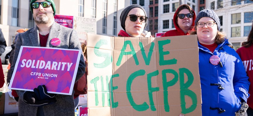 Demonstrators protest against cuts to the Consumer Financial Protection Bureau (CFPB) by President Trump and Elon Musks' DOGE initiative, as a hearing is scheduled to take place at the E. Barrett Prettyman United States Federal Court House in Washington, D.C., on March 3, 2025. Since taking office in January, Trump has launched a campaign to shrink the federal government.