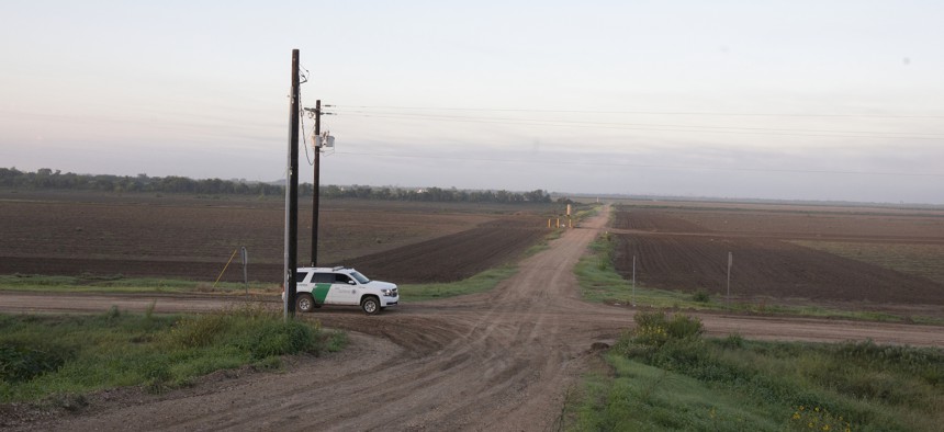 A U.S. Border Patrol vehicle stops on a farm road on June 25, 2024, outside McAllen, Texas. A shooting occurred at a U.S. Border Patrol facility in the city on Monday.