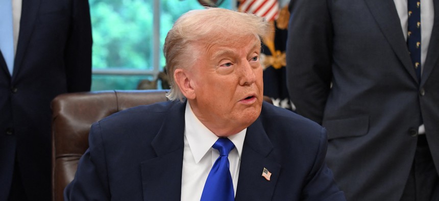 President Donald Trump speaks to the media while signing executive orders in the Oval Office on May 5, 2025. His latest EO is the latest effort to establish a tighter grip on the executive branch and its actions.