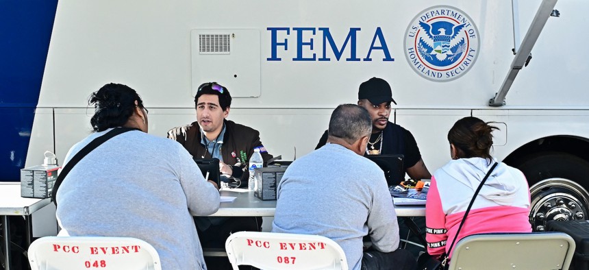 FEMA workers help residents who lost homes in the 2025 Los Angeles wildfires apply for aid.