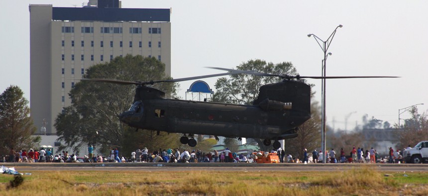 A large military helicopter lands on Interstate 10 near New Orleans during the rescue operations of residents trapped by flooding caused by Hurricane Katrina.