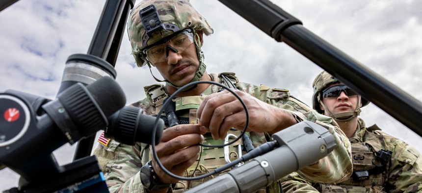 An explosive ordnance disposal soldier with the Army's 18th Military Police Brigade assembles a TiTAN drone-disrupter at U.S. Army Garrison Bavaria on July 8, 2025. 