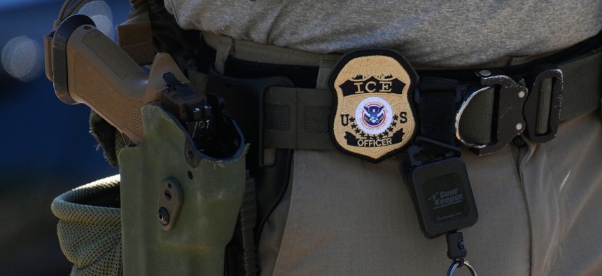An Immigration and Customs Enforcement officer's badge and weapon are seen as ICE conducts a vehicle checkpoint on Georgia Avenue in Washington, D.C., on Aug. 30, 2025.