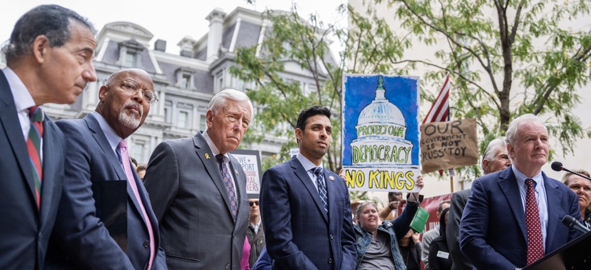 From left, Rep. Jamie Raskin, D-Md., Rep. Glenn Ivey, D-Md., Rep. Steny Hoyer, D-Md., Rep. Suhas Subramanyam, D-Va., furloughed National Institutes of Health employee Sara Hargrave, Rep. Don Beyer, D-Va., Sen. Chris Van Hollen, D-Md., and Rep. April McClain Delaney, D-Md. The Maryland and Virginia Congressional Democrats held a news conference across the street from the Eisenhower Executive Office Building on Oct. 14, 2025, to speak out against the Trump administration's "illegal mass firings of public servants.”