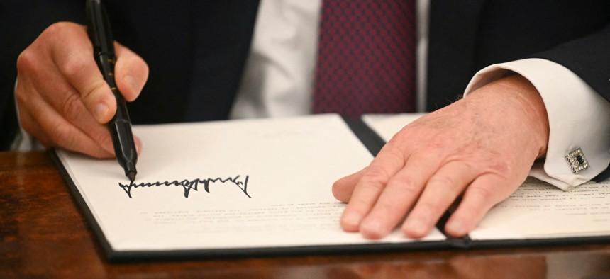 President Donald Trump signs executive orders in the Oval Office of the White House on Jan. 20, 2025. The president's most recent executive order requires agencies to create a strategic hiring committee to approve “the creation or filling” of each vacancy within the organization.
