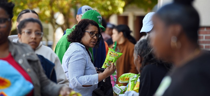Federal employees and contractors receive food items during a free food distribution in Hyattsville, Maryland, the United States, on Oct. 21, 2025.