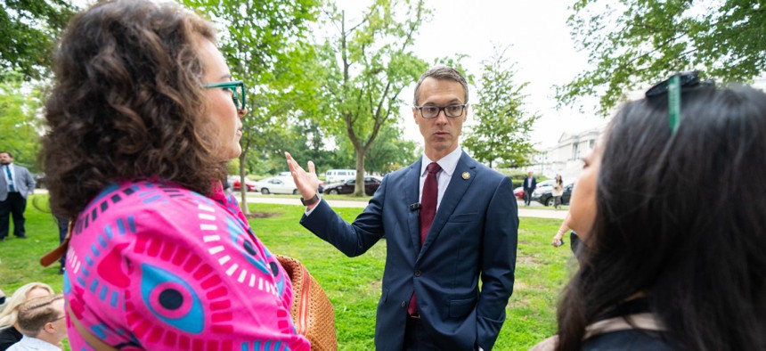 Rep. James Walkinshaw, D-Va., speaks with fired federal workers outside the U.S. Capitol on Sept. 30, 2025.