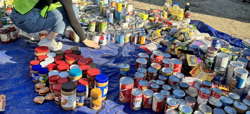 A volunteer organizes food donations at a protest outside of the Agriculture Department on Oct. 30.