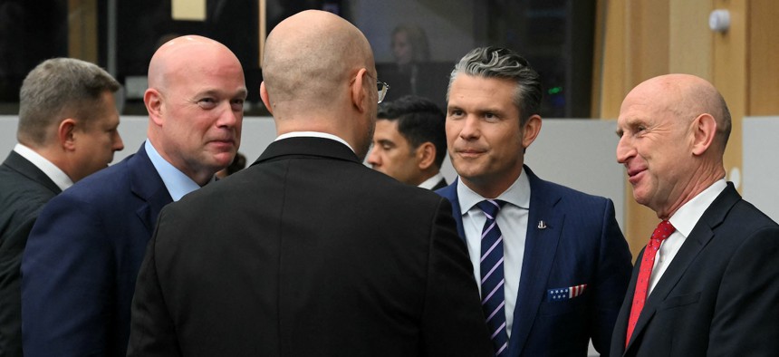 Defense Secretary Pete Hegseth and Britain's Defence Secretary John Healey talk to Ukraine's Defence Minister Denys Shmyhal as they arrive to attend the meeting of the Ukraine Defense Contact Group at the NATO headquarters in Brussels on October 15, 2025.