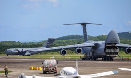 A U.S. Air Force C-17 Globemaster III, left, arrives at the Jose Aponte de la Torre Airport in Roosevelt Roads, Puerto Rico, as a C-5M Super Galaxy unloads on September 12, 2025.