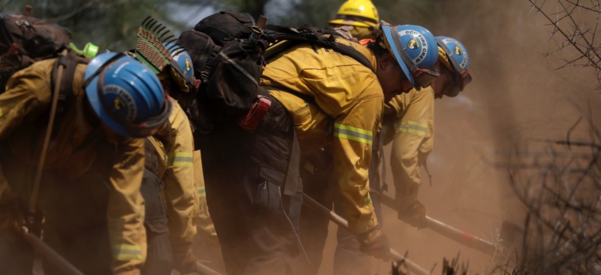 California Conservation Corps firefighters dig a line as they battle the 6-5 Fire in the TCU September Lightning Complex on Sept. 3, 2025, near Chinese Camp, California.