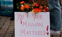 Flowers and a sign are seen as former United States Agency for International Development employees terminated after the Trump administration dismantled the agency collect their personal belongings at the USAID headquarters on Feb. 27, 2025 in Washington, D.C.