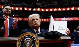 President Donald Trump holds up an executive order after signing it during an indoor inauguration parade at Capital One Arena on Jan. 20, 2025, in Washington, D.C. His administration has prioritized shrinking the federal workforce during his second term. 
