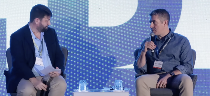John Hemmings, senior advisor to Pacific Forum, speaks to Mike Cadenazzi, assistant defense secretary for industrial base policy, during the Honolulu Defense Forum, Jan. 13, 2026.