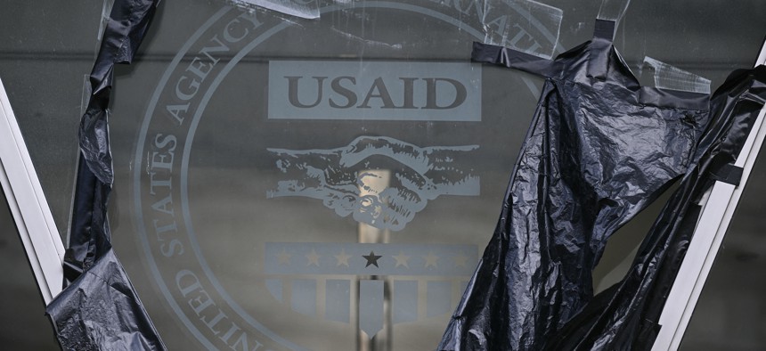 Remnants of signage for the U.S. Agency for International Development on the facade of the Ronald Reagan Building and International Trade Center building in Washington, D.C., on Dec. 29, 2025. The agency was dismantled earlier last year. 