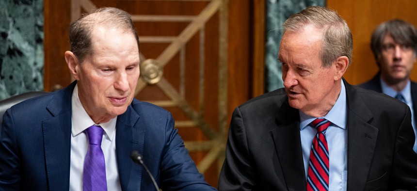 Sen. Ron Wyden, D-Ore., left, and chairman Sen. Mike Crapo, R-Idaho, talk before the start of a Senate Finance Committee hearing on Sept. 4, 2025.