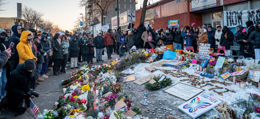 People pay their respects at a memorial site for Alex Pretti on Jan. 25, 2026 in Minneapolis, Minnesota. Pretti was shot and killed by federal agents amid a scuffle to arrest him on Jan. 24.