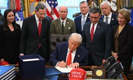 President Donald Trump signs a funding bill to end a partial government shutdown in the Oval Office of the White House on Feb. 3, 2026. The Trump administration continues to assert that federal workers aren't guaranteed back pay despite federal law explicitly assuring it.