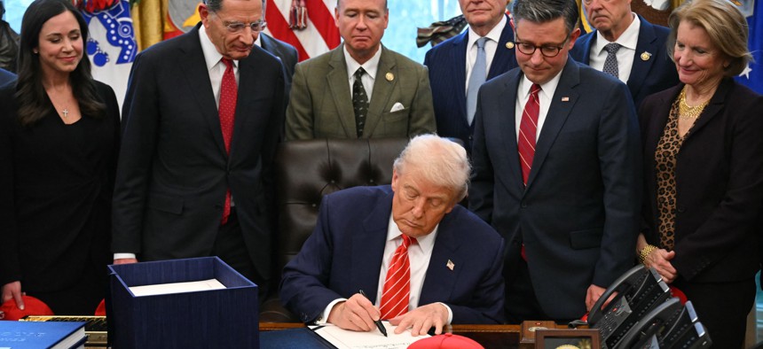 President Donald Trump signs a funding bill to end a partial government shutdown in the Oval Office of the White House on Feb. 3, 2026. The Trump administration continues to assert that federal workers aren't guaranteed backpay despite federal law explicitly assuring it.