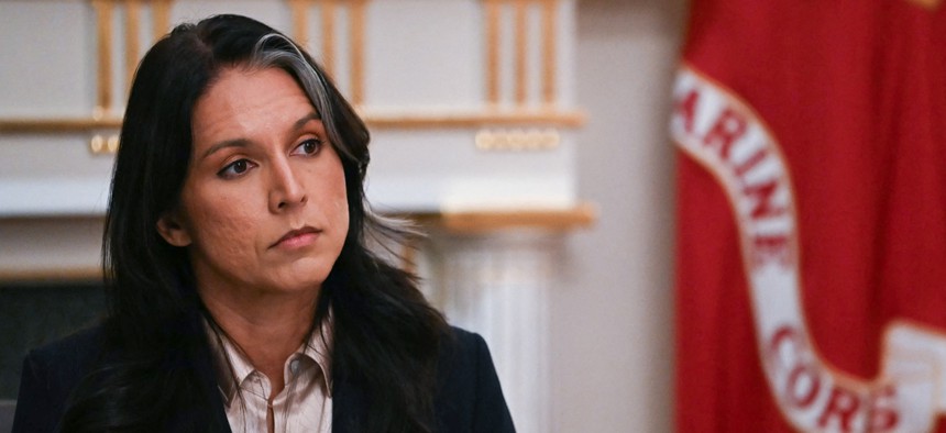 US Director of National Intelligence Tulsi Gabbard listens as President Donald Trump speaks during a Cabinet Meeting in the Cabinet Room of the White House in Washington, DC on December 2, 2025.