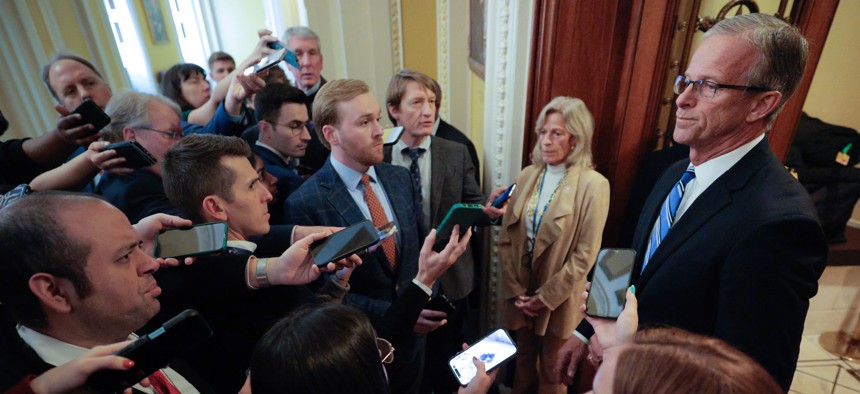 Senate Majority Leader John Thune, R-S.D., talks with reporters as he walks from his office to the Senate Chamber at the U.S. Capitol on Feb. 9, 2026. Congress is facing a Friday deadline to fund the Homeland Security Department, while language preventing reductions in force is also set to expire.