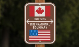 A sign marks the border between the U.S. and Canada at Peace Arch Park on Feb. 1, 2025. in Blaine, Washington. The number of agents assigned to the northern border has decreased by about 6%. 