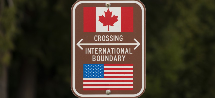 A sign marks the border between the U.S. and Canada at Peace Arch Park on Feb. 1, 2025. in Blaine, Washington. The number of agents assigned to the northern border has decreased by about 6%. 