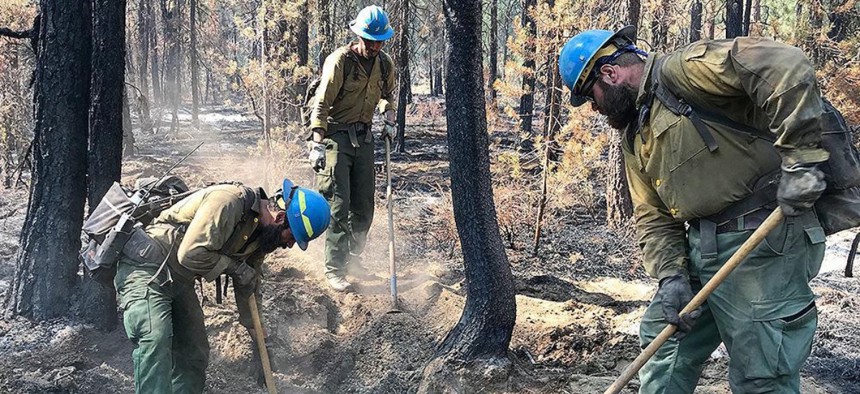 In this handout provided by the USDA Forest Service, firefighters work to control the Bootleg Fire on July 14, 2021 in Bly, Oregon. 