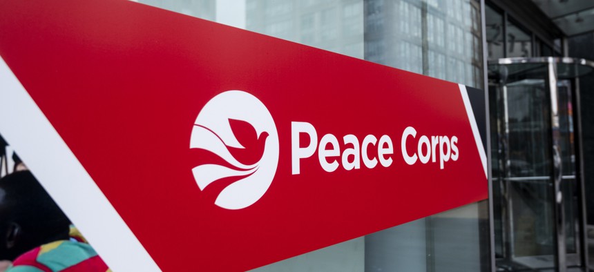 A sign marks the entrance to the Peace Corps headquarters in Washington, D.C., on Feb. 16, 2021. The agency wants to reduce the number of its full-time employees to 575. 