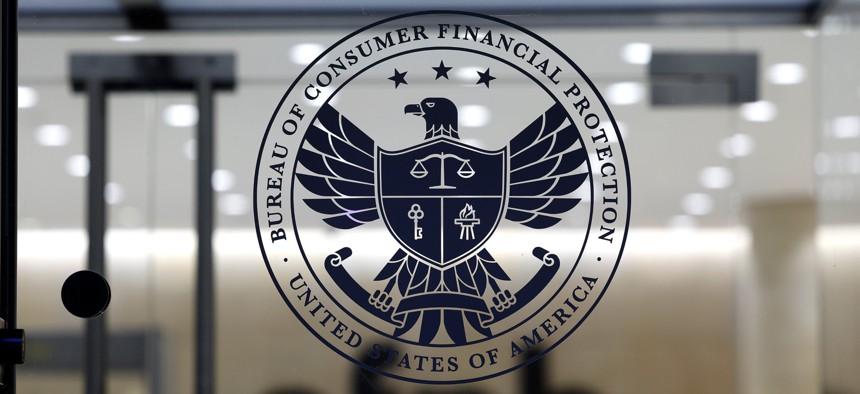 The entrance to the CFPB headquarters is seen during a protest on Feb. 10, 2025 in Washington, D.C. The U.S. Court of Appeals for the District of Columbia is currently weighing whether RIFs at the agency can proceed.